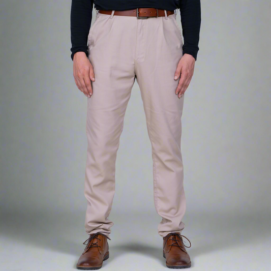 Khaki high rise chino pants shown front on a model, tailored fit through the thigh and tapered leg.