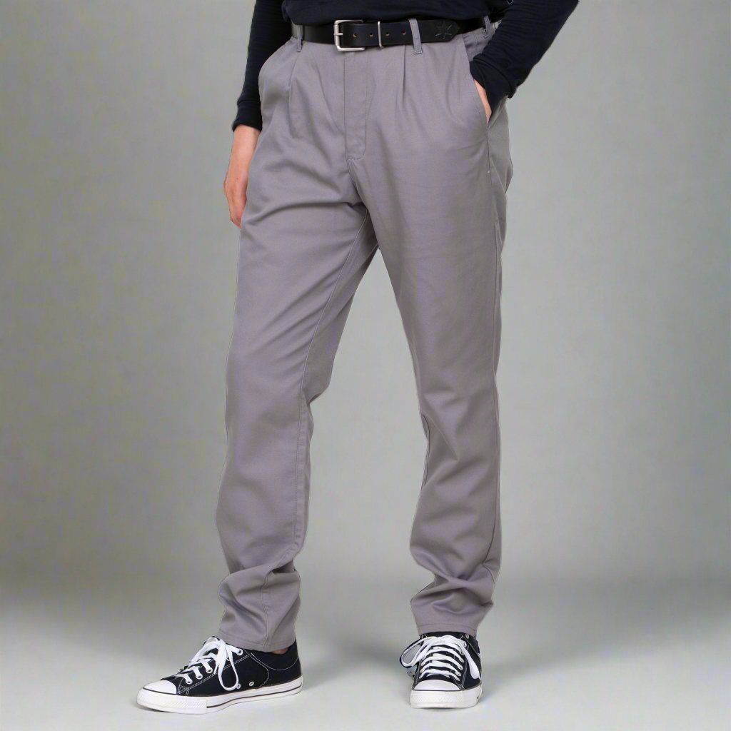 Person wearing gray pleated pants with a plain background
