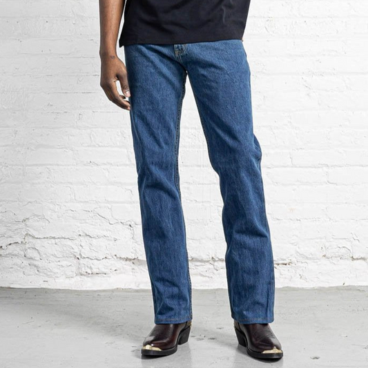 Stone wash boot cut jeans in faded indigo 100% cotton denim, shown flat from the front.