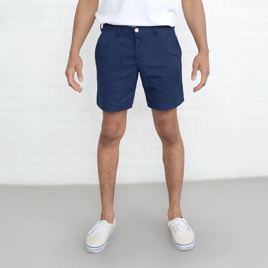 Navy chino shorts laid flat, front view, showing 7 inch length and button closure.
