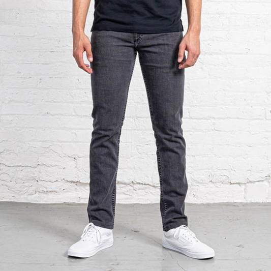 Slim fit grey wash jeans shown flat from the front, with tapered leg, five pockets and a leather patch at the waist.