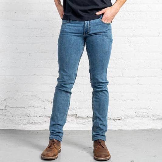Slim fit men's jeans in a light wash stretch denim, shown front view with tapered leg.
