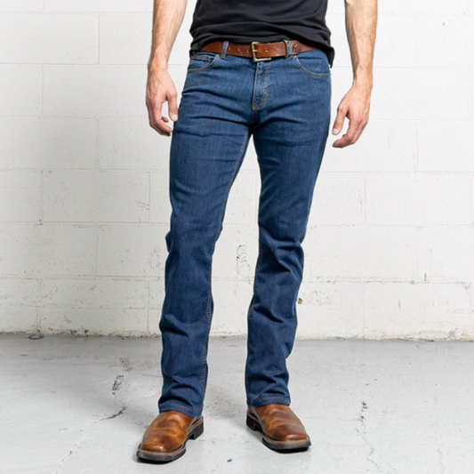 Boot cut men's jeans in a medium blue stone wash, shown front-on with a leather patch at the waistband.