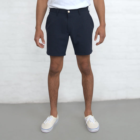 Navy technical shorts shown flat from the front with belt loops and front pockets visible.