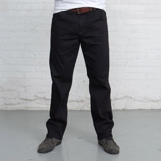 Front view of black relaxed fit jeans with five pockets and a gold leaf button.